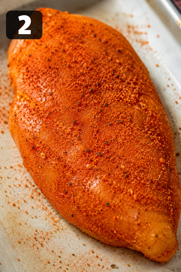 Seasoned chicken breasts ready for smoking