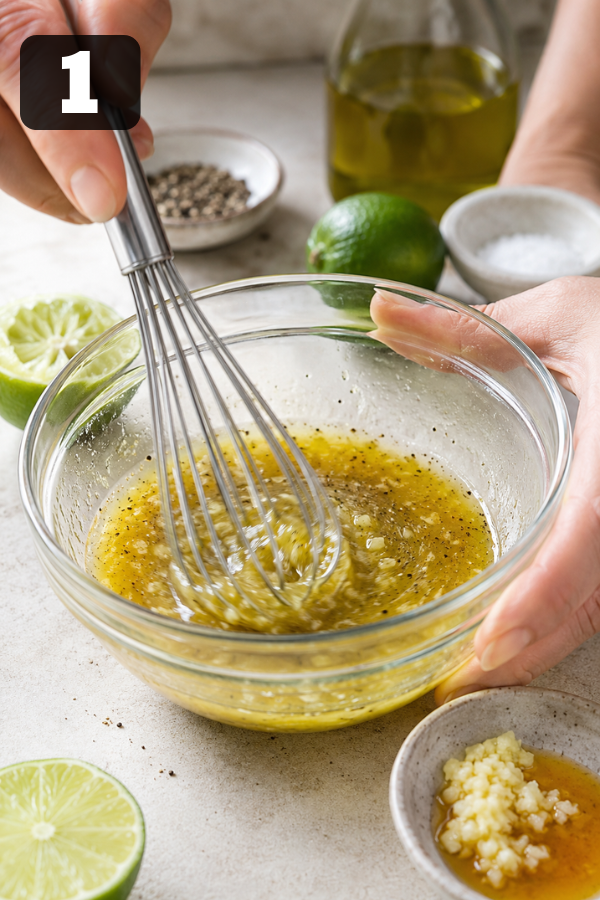 Whisking fresh lime juice, olive oil, honey, garlic, salt, and pepper into a simple zesty lime dressing.