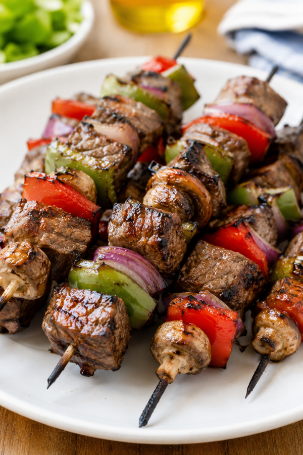 Grilled steak kabobs with bell peppers, zucchini, red onion, mushrooms, and summer herbs