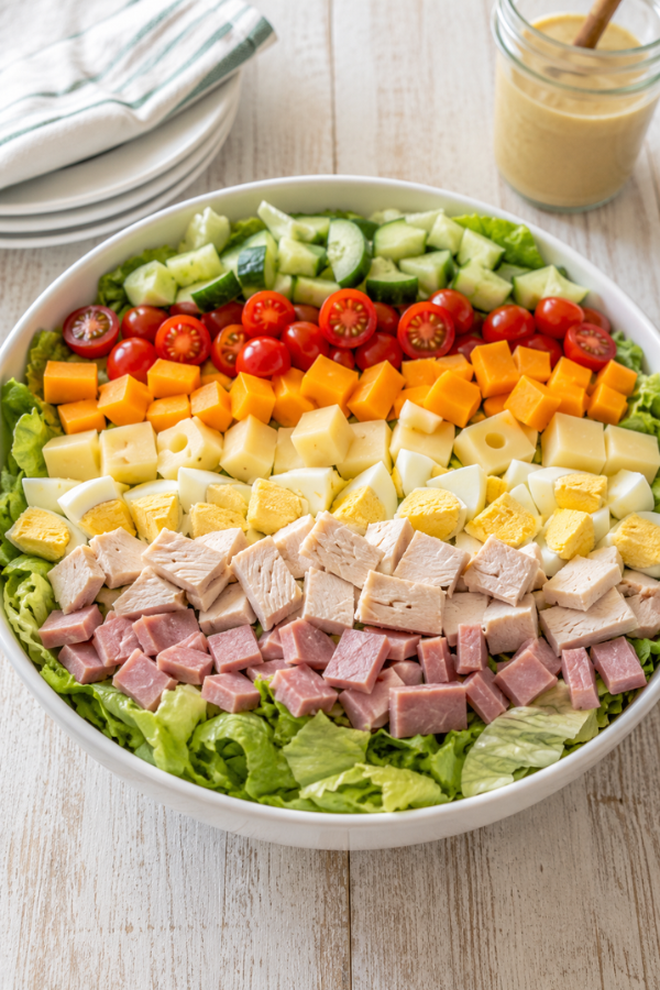 Classic chef salad for a healthy high protein anti-inflammatory dinner with greens, eggs, turkey, cheese, tomatoes, and cucumber