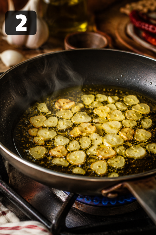 Garlic and chili flakes gently sizzling in olive oil for classic Italian garlic spaghetti