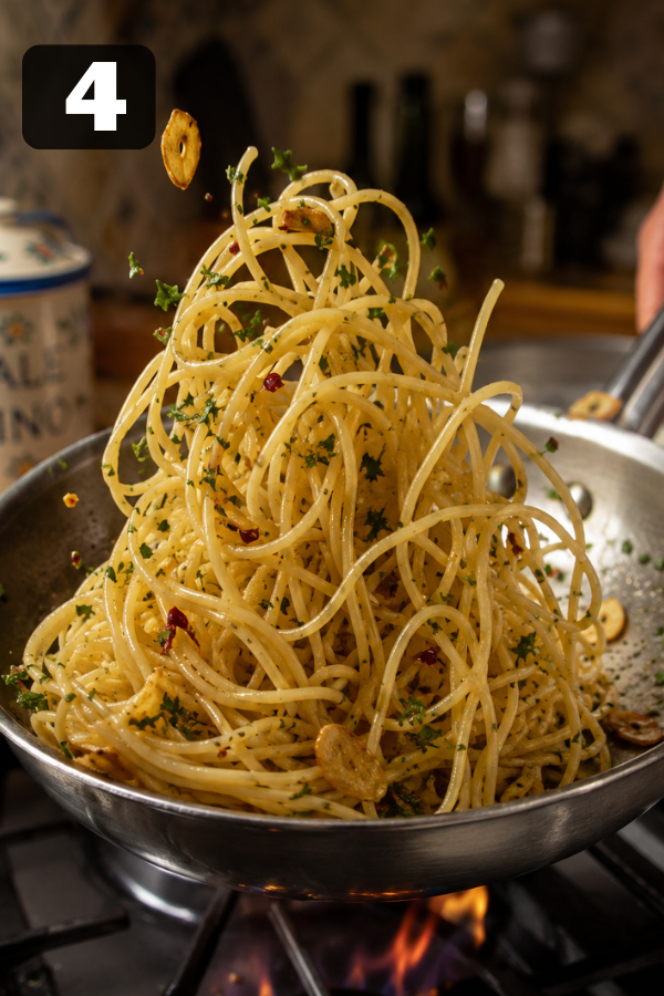 Cooked spaghetti tossed with garlic oil sauce for Spaghetti Aglio e Olio