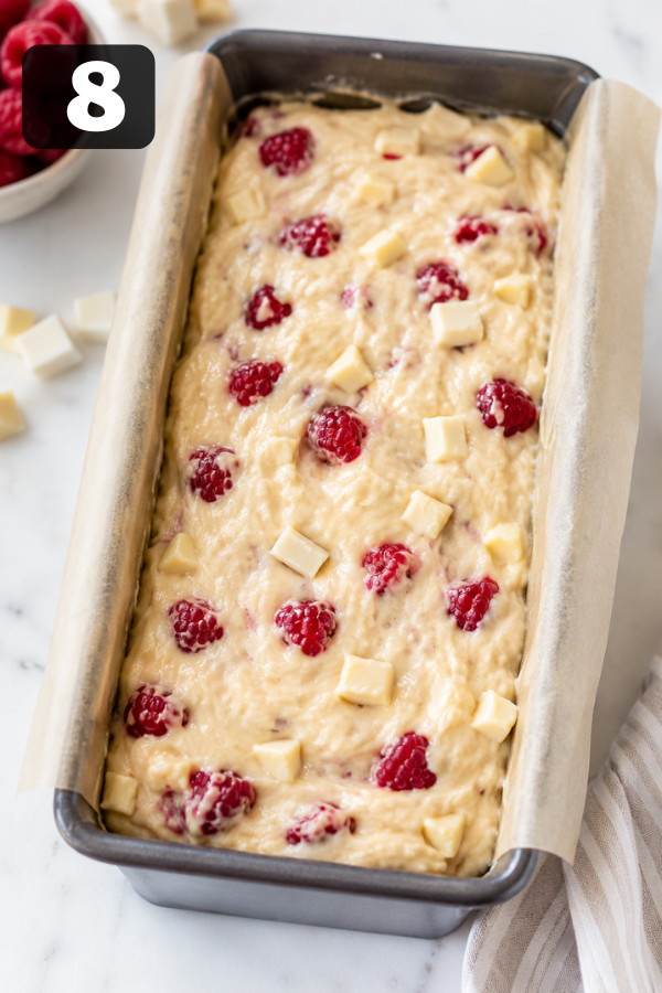 Pouring loaf cake batter into prepared pan before baking in oven