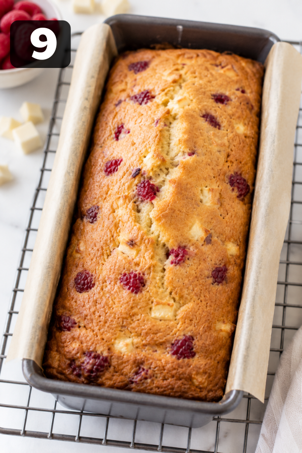 Cooling baked raspberry white chocolate loaf cake on wire rack after removing from pan