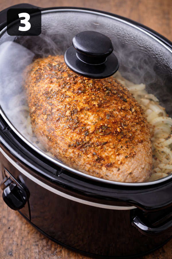 turkey breast cooking in slow cooker with steam and seasonings