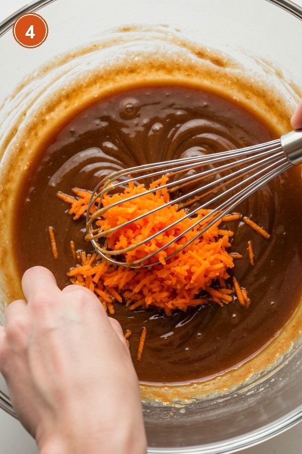Step 4: Whisking oil, brown sugar, eggs and freshly grated orange carrots in large bowl