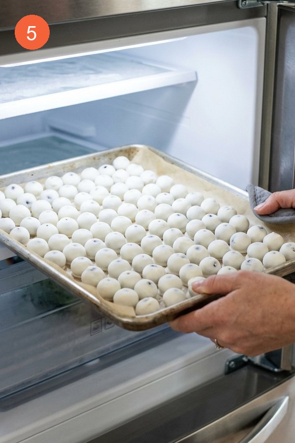 tray of yogurt coated blueberries going into freezer